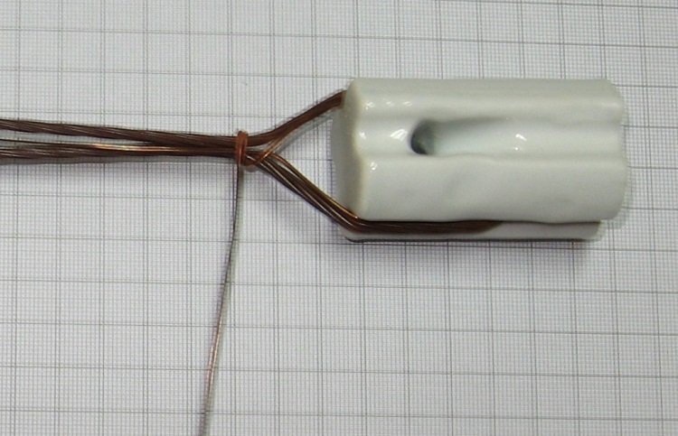 Photo#3. The sorter tail side of the tie wire is laid along the antenna wire and tail with the longer side wound on tightly binding the antenna wire, tail and sort side of the tie wire together.