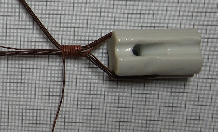 Photo#4. Rap for at least 10 turns and bend the main antenna wire away as above.
